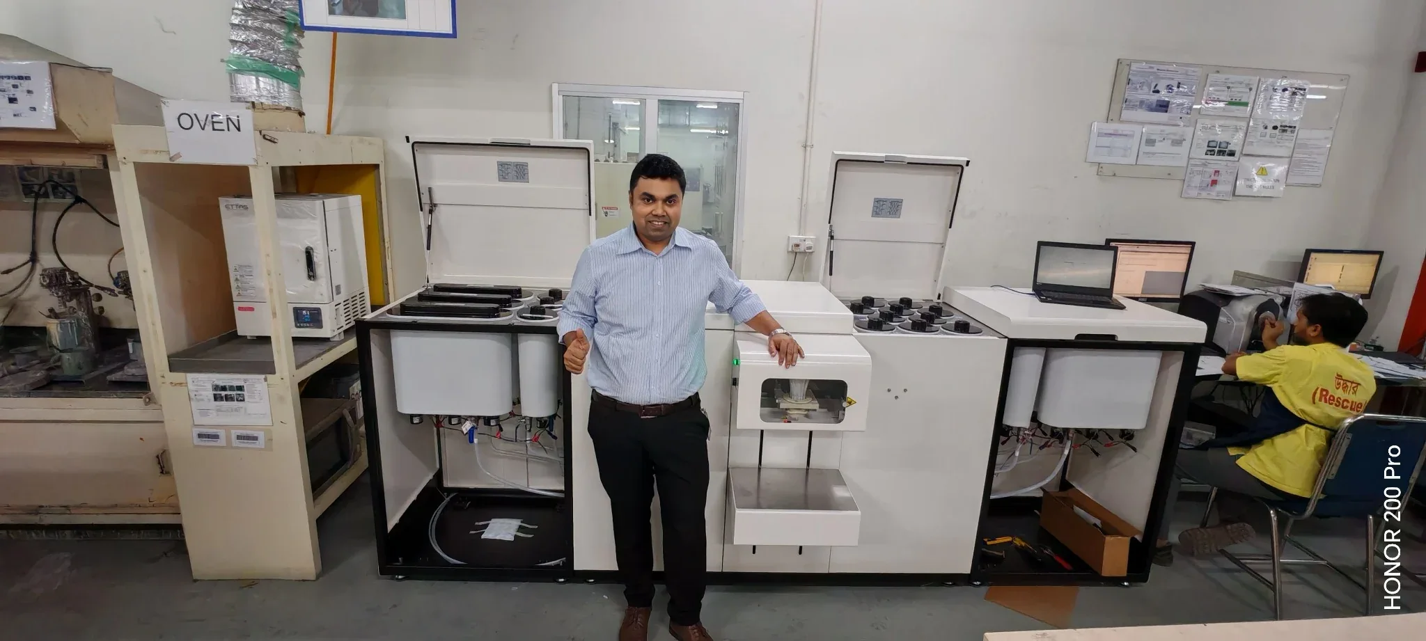 Impro Solutions technical representative beside the SANTINT automatic paint tinting and colorant dispensing system at a Bangladesh client site